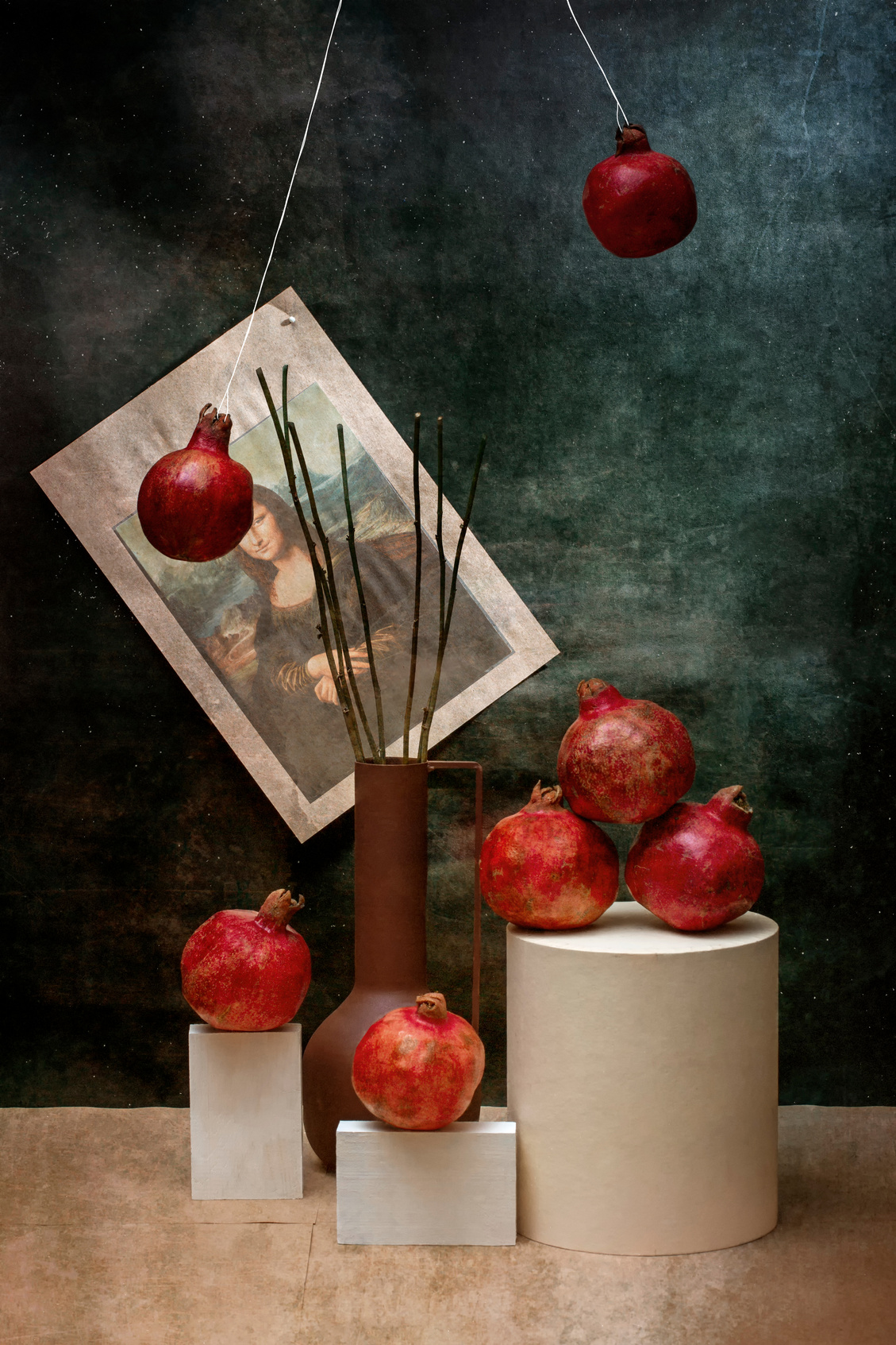 Still life with ripe pomegranates and a picture of the Mona Lisa